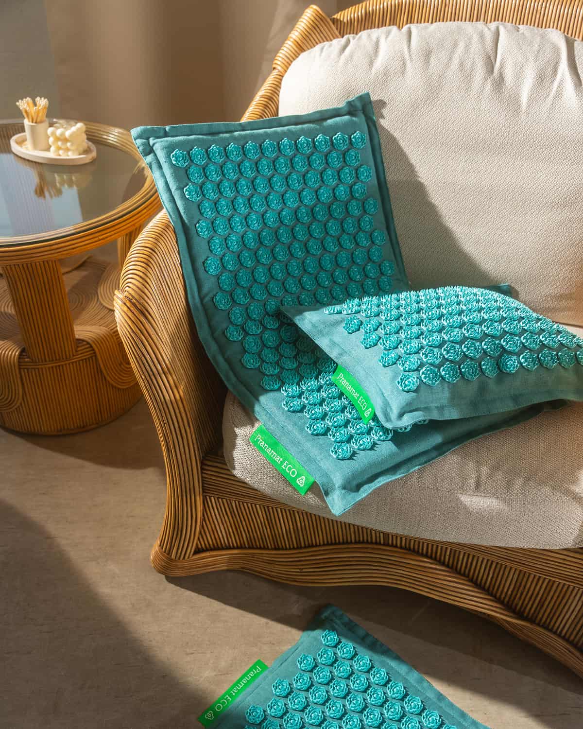 Turquoise Pranamat set on a rattan armchair