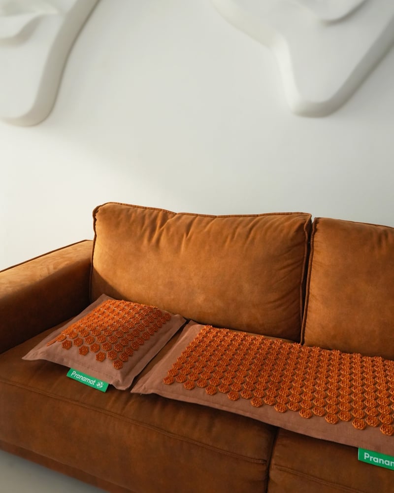 Caramel Pranamat set on a warm brown sofa
