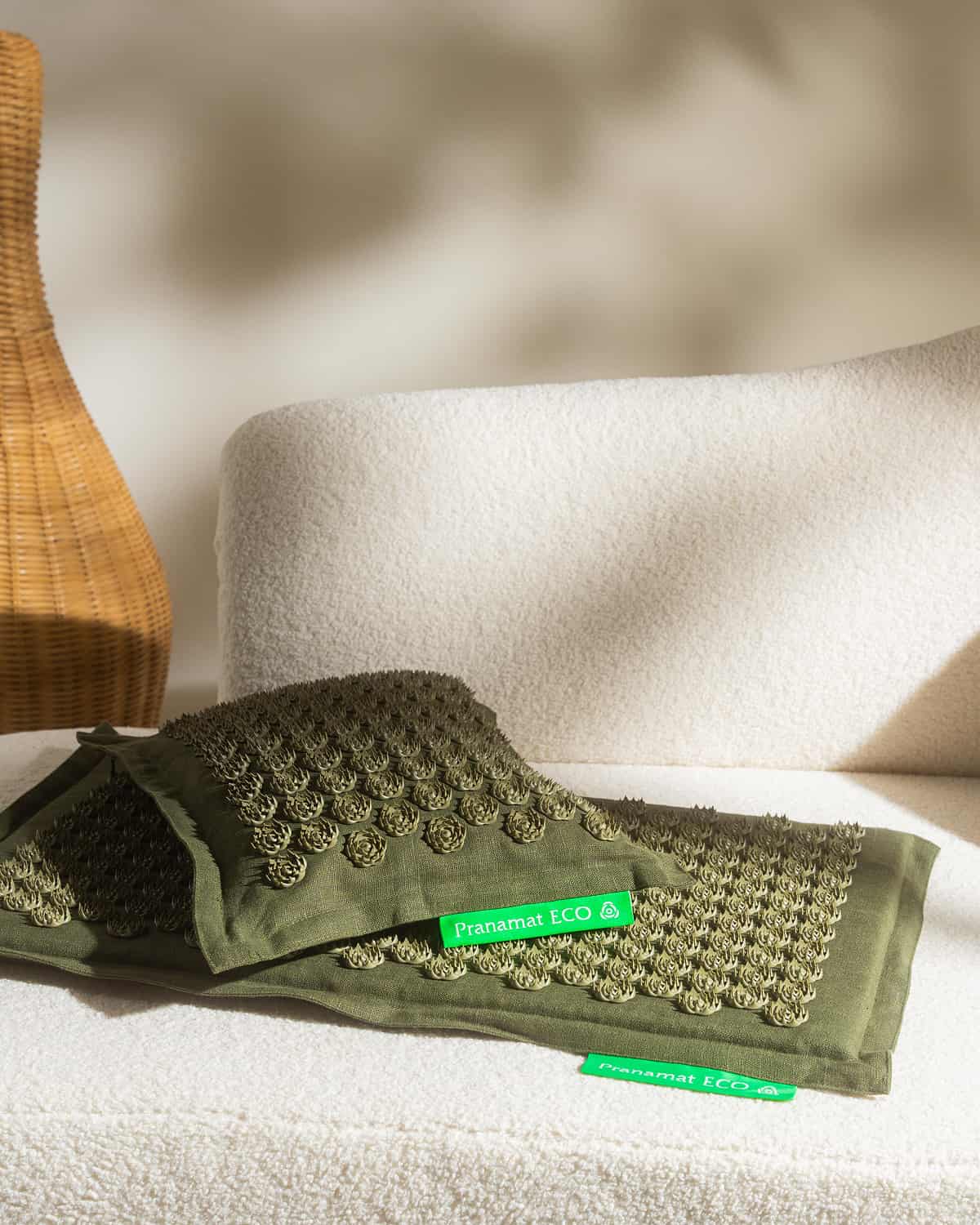 Olive Pranamat ECO set on a white sofa